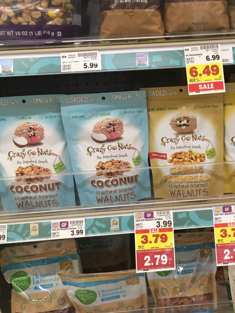 A store shelf displaying bags of Crazy Go Nuts walnuts. 