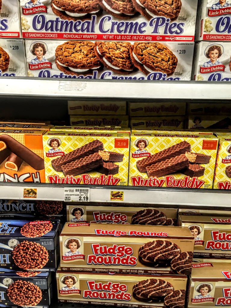 A store shelf displaying Little Debbie Nutty Buddy snacks. 